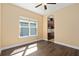 Bright bedroom with hardwood floors and a window offering natural light and backyard views at 1392 Zeek Ridge St, Clermont, FL 34715