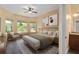 Bright bedroom suite showcasing a king bed, stylish decor, and an adjacent bathroom with modern fixtures at 1392 Zeek Ridge St, Clermont, FL 34715