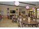 Clubhouse interior featuring tables, chairs, and decorative lighting for community gatherings at 1392 Zeek Ridge St, Clermont, FL 34715