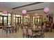 The community clubhouse features lovely decor, tables, and plenty of light from the many windows at 1392 Zeek Ridge St, Clermont, FL 34715