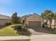 Beautiful home featuring well-maintained landscaping, a paver driveway, and an attached two-car garage at 1392 Zeek Ridge St, Clermont, FL 34715
