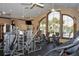 The community fitness center includes lots of modern workout equipment, ceiling fans, and large windows at 1392 Zeek Ridge St, Clermont, FL 34715