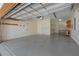 Spacious two car garage features epoxy flooring, ample storage, and pegboard walls, ideal for projects and organization at 1392 Zeek Ridge St, Clermont, FL 34715