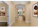 Inviting hallway leads to an open living area with tile flooring and decorative art pieces at 1392 Zeek Ridge St, Clermont, FL 34715