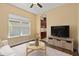 Cozy living room featuring a large window, modern furniture, and a view into the kitchen at 1392 Zeek Ridge St, Clermont, FL 34715