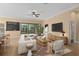 Well-decorated living room featuring neutral tones, stylish furniture, a chalkboard wall, and sliding glass doors at 1392 Zeek Ridge St, Clermont, FL 34715