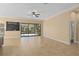 Spacious living area with tile flooring, a chalkboard wall, and sliding glass doors to the screened lanai at 1392 Zeek Ridge St, Clermont, FL 34715