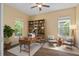 Bright office with wood floors, built-in shelves, and a large window for ample natural light at 1392 Zeek Ridge St, Clermont, FL 34715