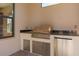 Built-in outdoor kitchen featuring stainless steel appliances and granite countertop, ideal for entertaining guests at 1392 Zeek Ridge St, Clermont, FL 34715