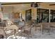 Outdoor kitchen and lounge area with a grill, outdoor seating, and a television for residents to enjoy at 1392 Zeek Ridge St, Clermont, FL 34715