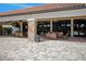 Inviting clubhouse patio with comfortable seating, elegant stone pillars, ceiling fans, and a view of the community amenities at 1392 Zeek Ridge St, Clermont, FL 34715