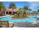 Relaxing community pool with lush landscaping, patio seating, and inviting lounge chairs at 1392 Zeek Ridge St, Clermont, FL 34715