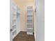 Well-organized walk-in closet with built-in shelves and storage, providing ample space at 1392 Zeek Ridge St, Clermont, FL 34715