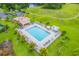 Stunning aerial view of community pool, surrounded by palm trees and manicured grounds at 1401 Royal Saint George Dr, Orlando, FL 32828