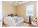 Cozy bedroom featuring a ceiling fan and a large window providing natural light at 1401 Royal Saint George Dr, Orlando, FL 32828