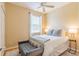 Comfortable bedroom with a ceiling fan, bright window and a plush bench at 1401 Royal Saint George Dr, Orlando, FL 32828