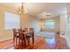Traditional dining room features a wooden table set and wood flooring at 1401 Royal Saint George Dr, Orlando, FL 32828