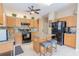 Spacious kitchen with wooden cabinets, granite counters and a center island with seating at 1401 Royal Saint George Dr, Orlando, FL 32828