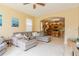Comfortable living room with a gray sectional couch, neutral paint, and an open archway at 1401 Royal Saint George Dr, Orlando, FL 32828