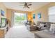Inviting living room with view of the lake, cozy sectional, and neutral color palette at 1401 Royal Saint George Dr, Orlando, FL 32828