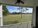 A cozy balcony with a ceiling fan overlooks a lush green expanse, offering scenic views and a tranquil outdoor space at 14025 Fairway Island Dr # S, Orlando, FL 32837