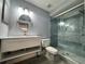 Modern bathroom with a large glass shower, blue tiled walls, and updated lighting at 14025 Fairway Island Dr # S, Orlando, FL 32837