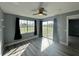 Bedroom with wood-look floors, neutral paint, and a sliding glass door to an outdoor balcony at 14025 Fairway Island Dr # S, Orlando, FL 32837