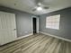 Bedroom featuring a ceiling fan, wood-look floors, and a closet for storage at 14025 Fairway Island Dr # S, Orlando, FL 32837