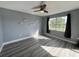 Bedroom featuring wood-look floors, a ceiling fan, and natural light from the window at 14025 Fairway Island Dr # S, Orlando, FL 32837