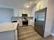 Renovated kitchen showcasing stainless steel appliances, bright lighting, and eat in counter at 14025 Fairway Island Dr # S, Orlando, FL 32837