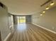 Spacious living room with wood floors, great light, and access to outdoor balcony at 14025 Fairway Island Dr # S, Orlando, FL 32837
