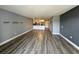 Spacious living room with wood-look flooring that flows into the kitchen and dining area at 14025 Fairway Island Dr # S, Orlando, FL 32837