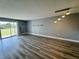 Bright living room featuring modern flooring, neutral paint, and access to balcony at 14025 Fairway Island Dr # S, Orlando, FL 32837