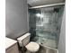 Bathroom featuring a large glass shower with blue tiled walls, plus modern toilet and vanity at 14025 Fairway Island Dr # S, Orlando, FL 32837