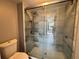 Updated bathroom with a large walk-in shower featuring sliding glass doors and tiled walls at 14025 Fairway Island Dr # S, Orlando, FL 32837