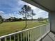 Balcony view overlooking golf course with a large tree in the foreground, and blue skies above at 14025 Fairway Island Dr # S, Orlando, FL 32837