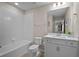 Bright bathroom with tile floors, all white features, and walk-in shower at 14146 Lanikai Beach Dr, Orlando, FL 32827