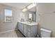 Bright bathroom featuring a dual sink vanity with modern fixtures and ample storage at 14146 Lanikai Beach Dr, Orlando, FL 32827