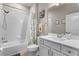 Clean bathroom with a shower-tub combo, white cabinets, modern fixtures, and a decorative shower curtain at 14146 Lanikai Beach Dr, Orlando, FL 32827