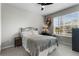 A bright bedroom with neutral colors, carpet, a window with natural light, and minimal furnishings at 14146 Lanikai Beach Dr, Orlando, FL 32827
