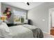Bright and airy bedroom with a large window, gray carpet, and views of the neighborhood at 14146 Lanikai Beach Dr, Orlando, FL 32827