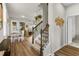 Inviting entryway featuring hardwood floors and a staircase with decorative wrought iron at 14146 Lanikai Beach Dr, Orlando, FL 32827