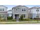 Charming two-story home with a manicured lawn and inviting front porch at 14146 Lanikai Beach Dr, Orlando, FL 32827