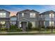 Charming two-story home with a manicured lawn and inviting front porch at dusk at 14146 Lanikai Beach Dr, Orlando, FL 32827