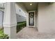 Inviting front porch with a decorative wreath and brick pavers at 14146 Lanikai Beach Dr, Orlando, FL 32827