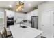 Bright kitchen featuring white cabinets, stainless steel appliances, and a center island at 14146 Lanikai Beach Dr, Orlando, FL 32827