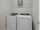 Convenient laundry room featuring modern, white washer and dryer units at 14146 Lanikai Beach Dr, Orlando, FL 32827