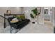 Cozy upstairs loft with a comfortable black sofa and nearby bathroom at 14146 Lanikai Beach Dr, Orlando, FL 32827