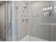 Modern glass shower with tiled walls, sleek fixtures and shower-head at 14146 Lanikai Beach Dr, Orlando, FL 32827