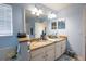 Bright bathroom featuring a double sink vanity with granite countertops and tile flooring at 14415 Estrella Dr, Orlando, FL 32837
